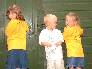 Chloe, Fraser and Ellie model the 2002 T-shirt